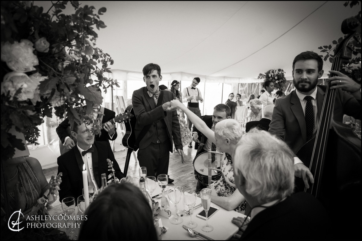 Travelling minstrels entertain wedding guests during dinner