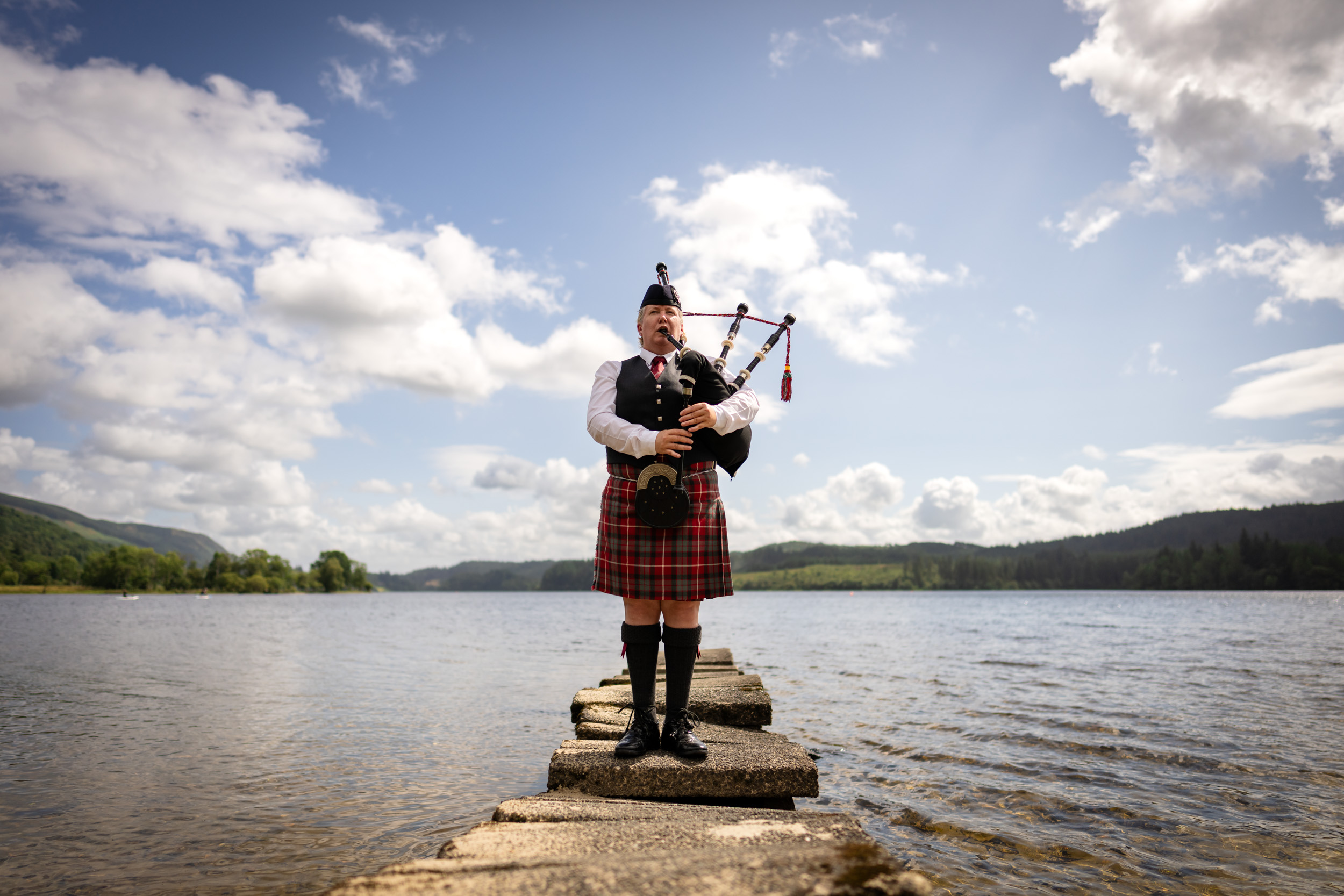 Piper by loch at Kinlochard wedding