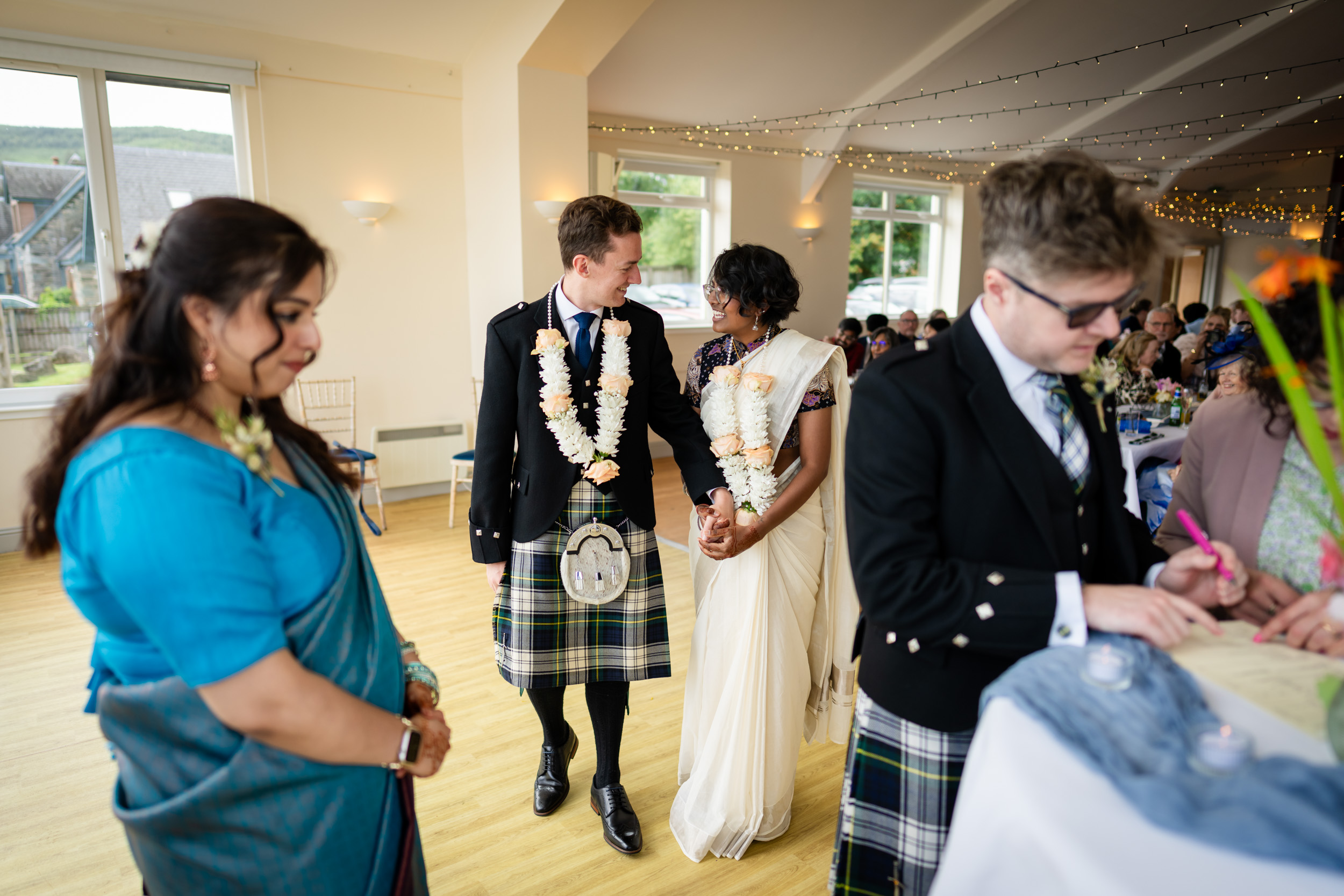 Couple in flower garlands at Scottish Indian wedding